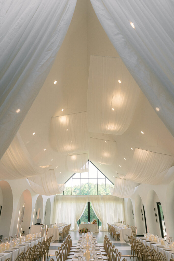 Dramatic drapery hanging from the ceiling in wedding reception space at The Lumen House