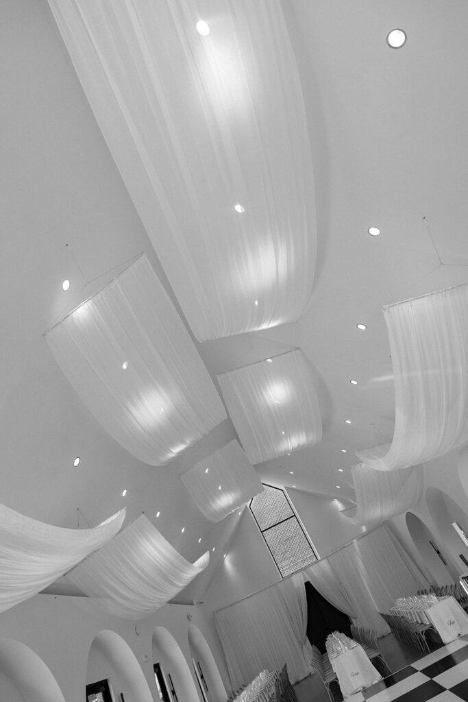 Dramatic drapery hanging from the ceiling in wedding reception space at The Lumen House